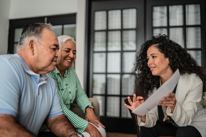 Personal injury lawyer having a meeting with senior couple at home
