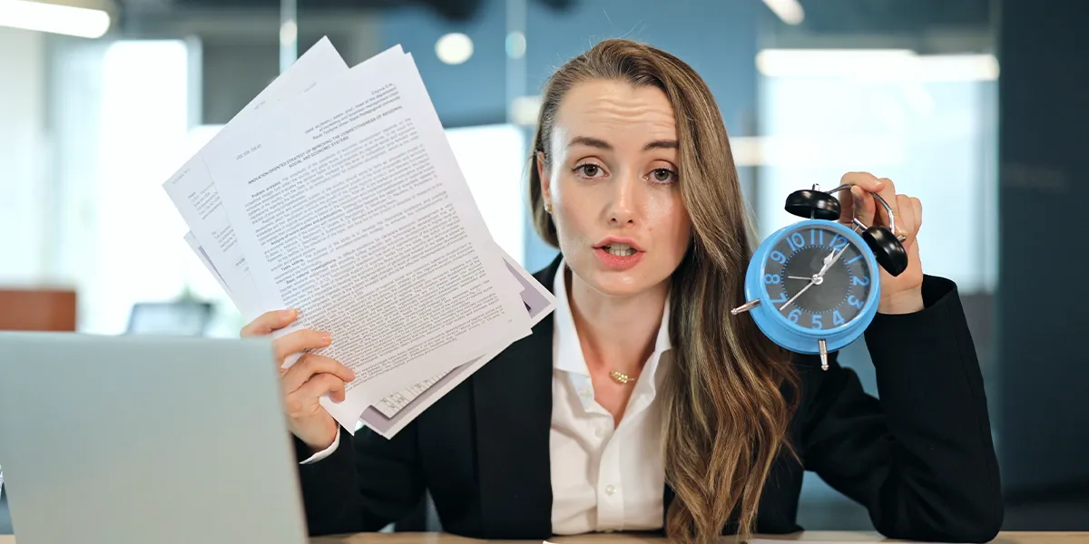 Lawyer holding a clock and papers that are urgent to review